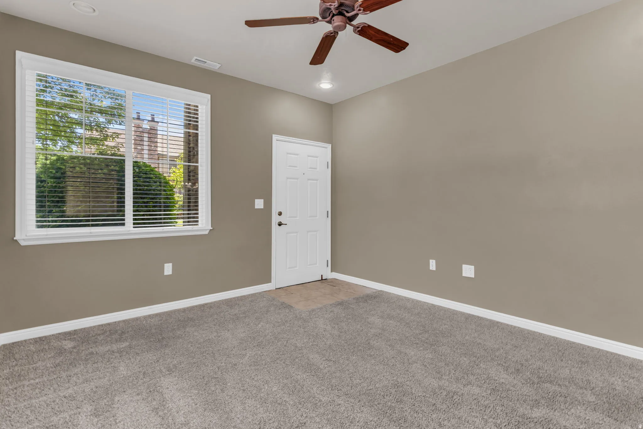 Bright open-concept living space filled with natural light from large windows.