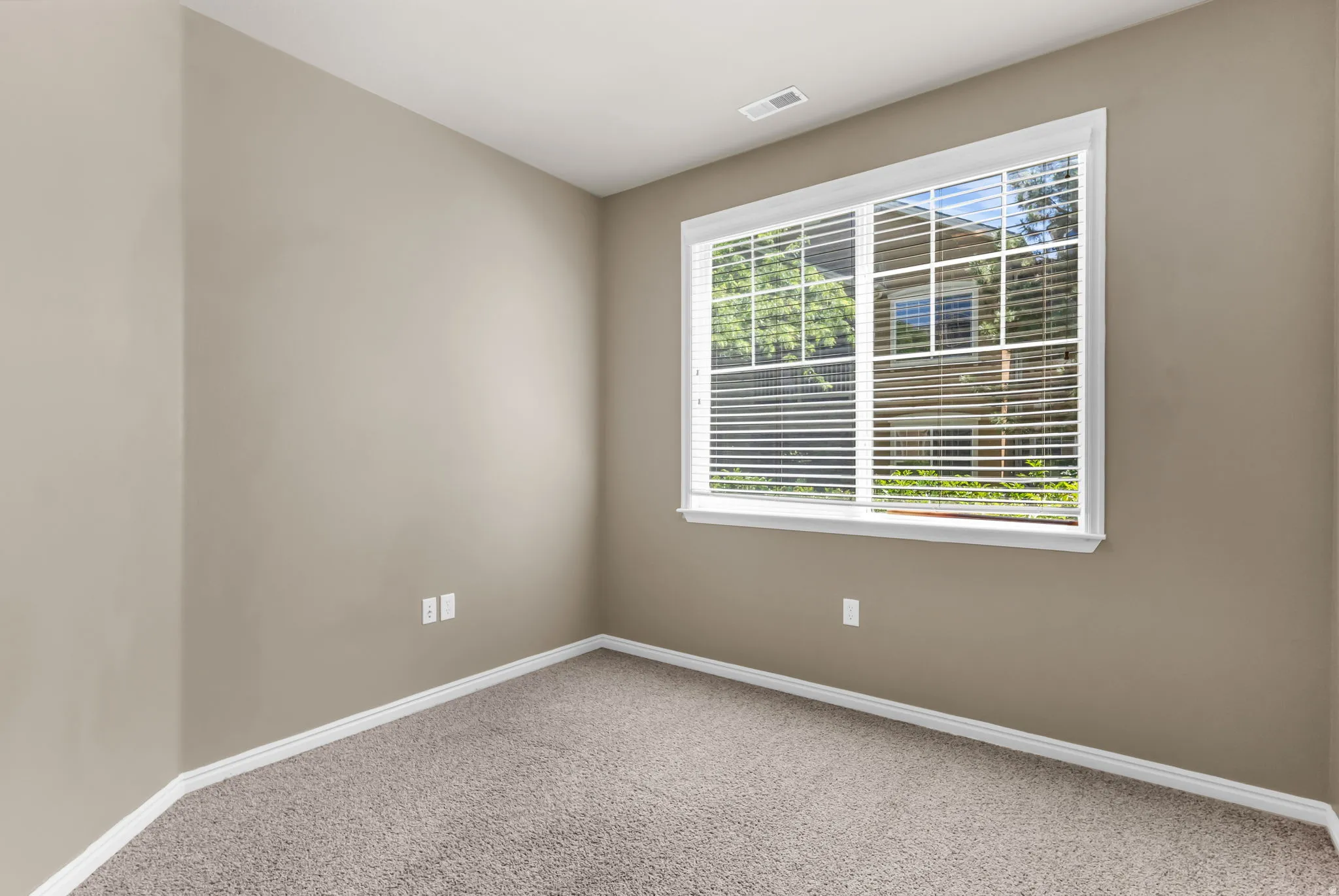 Well-sized 2nd bedroom featuring a walk-in closet. with versatile use potential for guests or office.