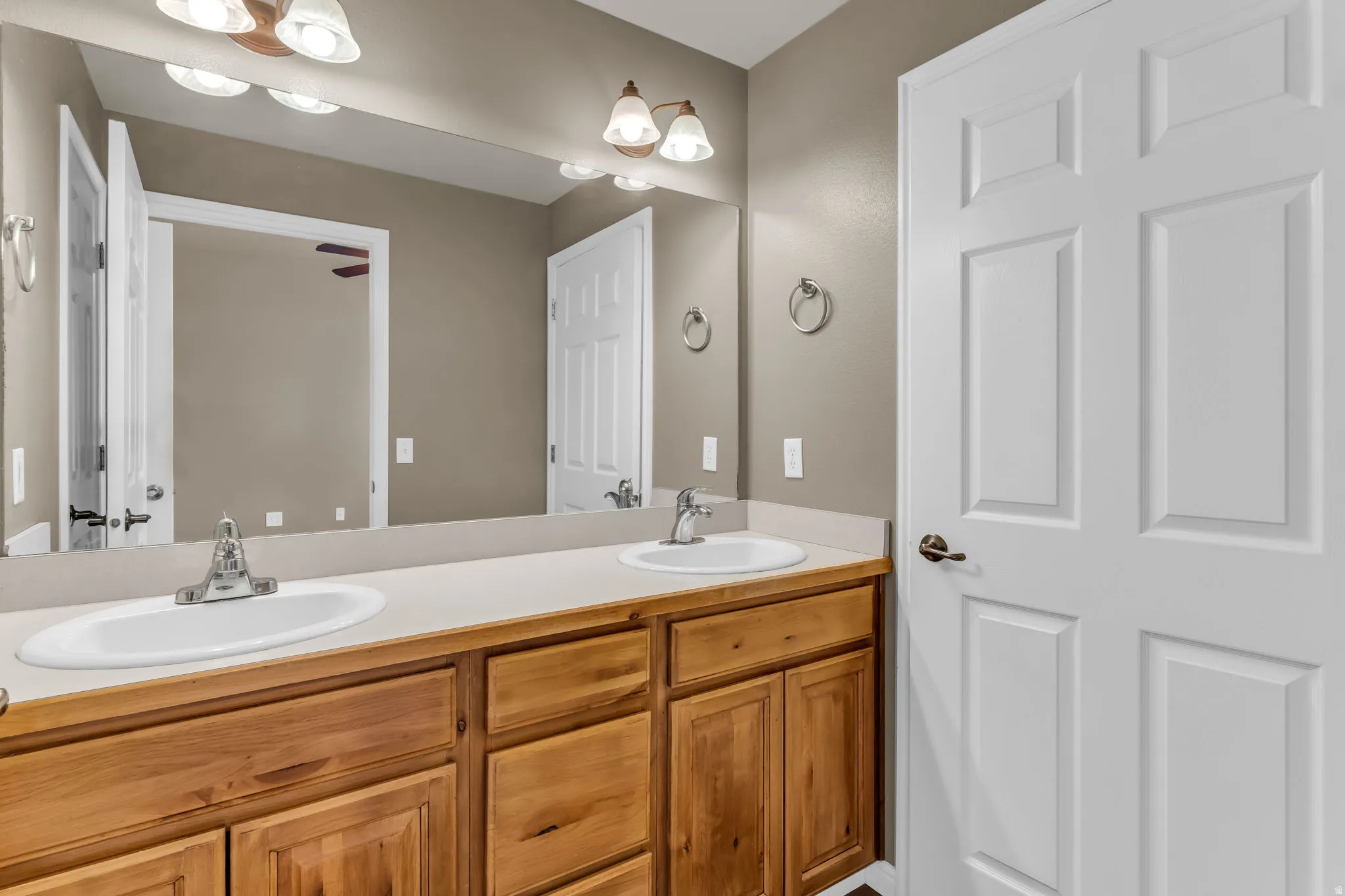 Private bath featuring a clean, functional design with a double vanity.