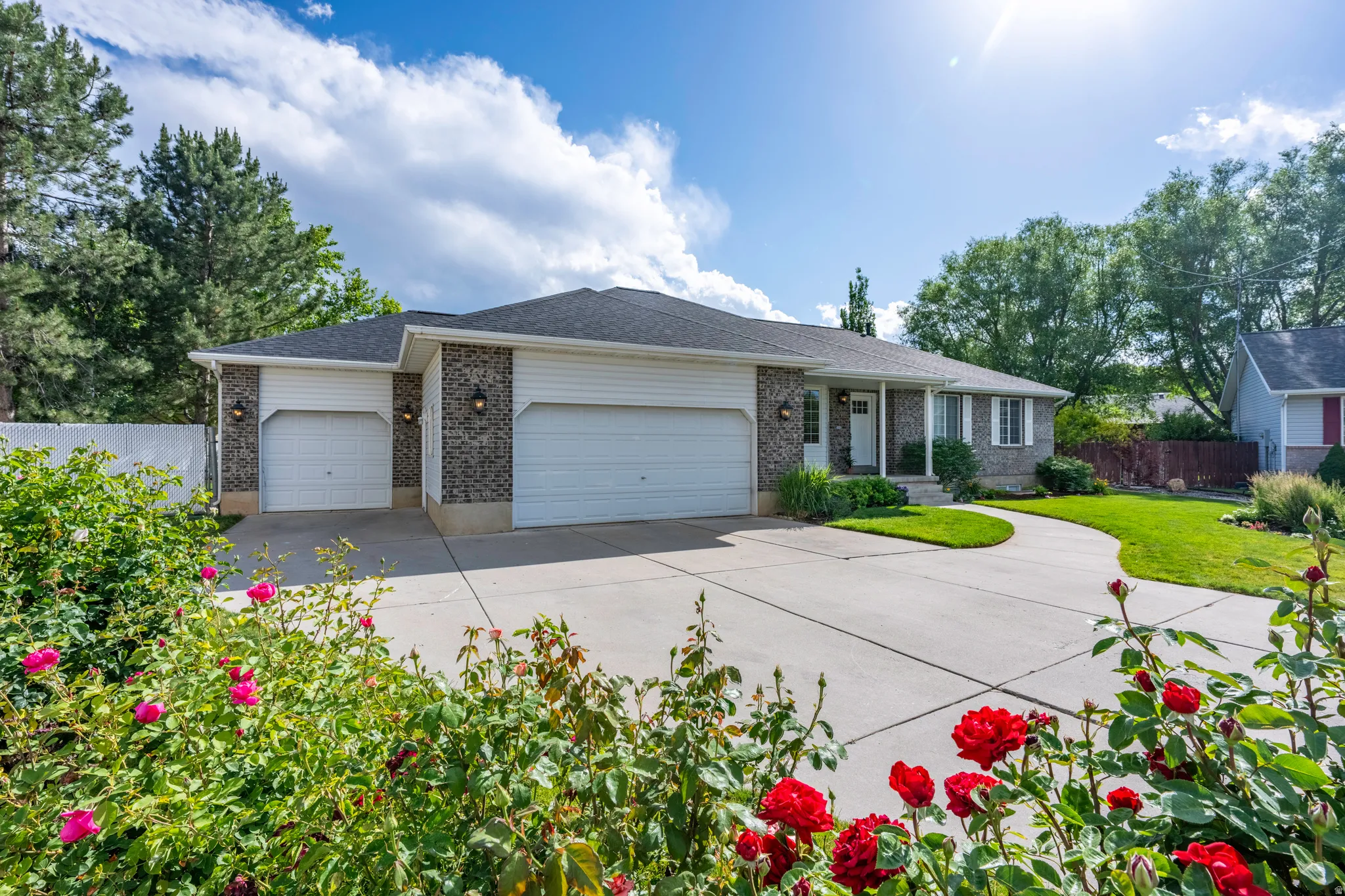 Rambler-style exterior featuring stone and siding finishes