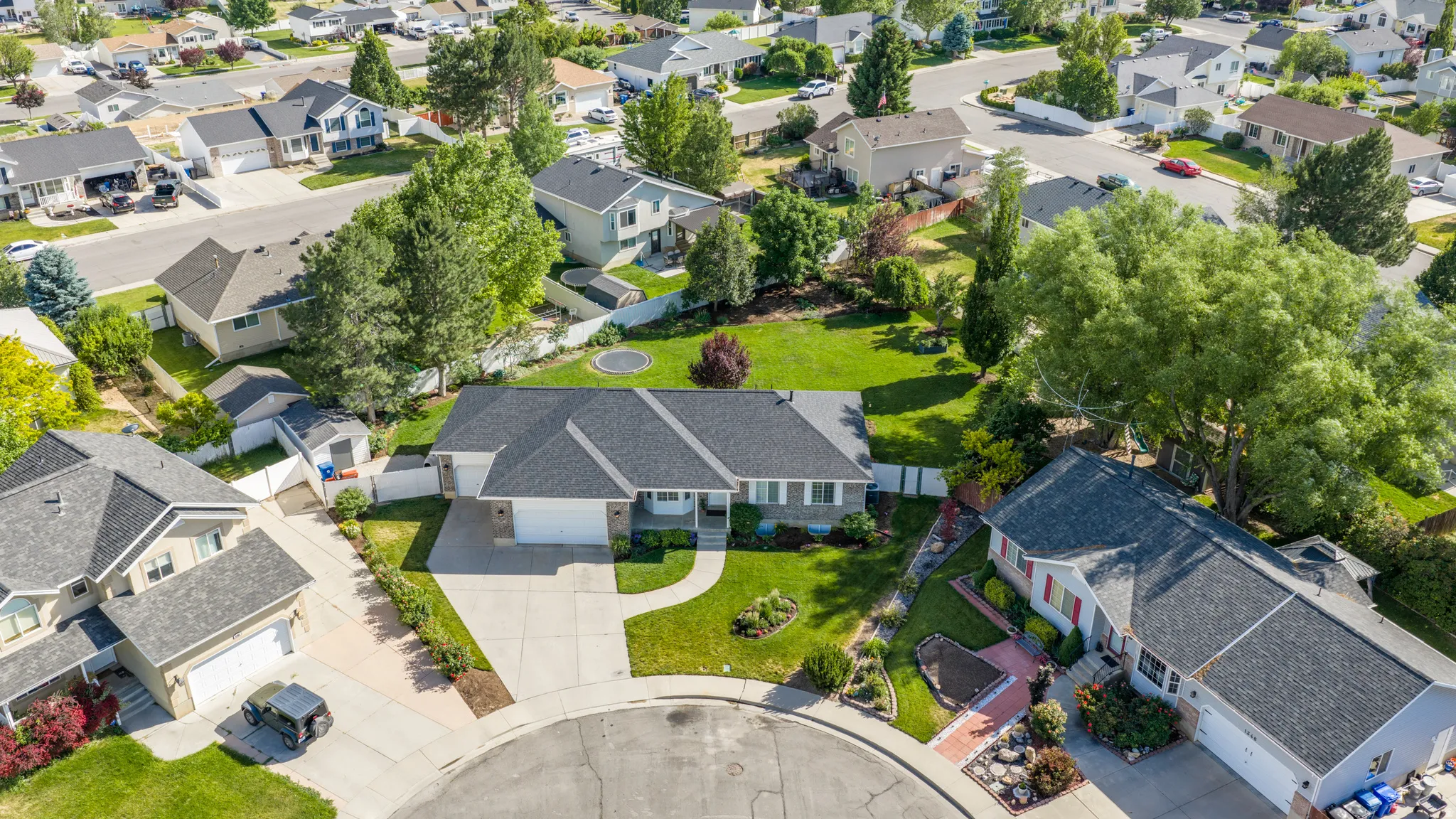 Single-story residence featuring a gray shingle roof and a two-car garage