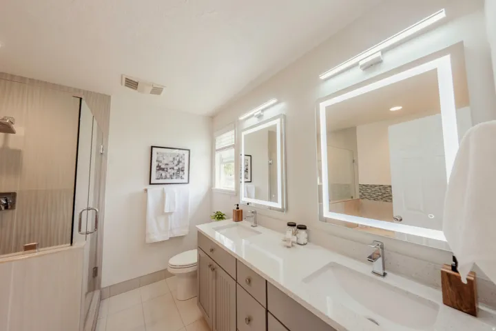 Dual vanity featuring integrated sinks and chrome fixtures
