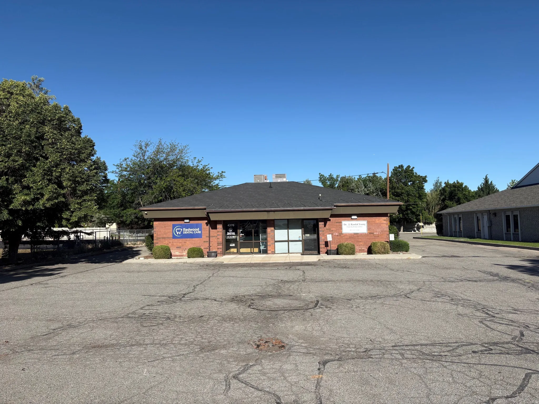 Brick exterior commercial building with a black asphalt shingle roof
