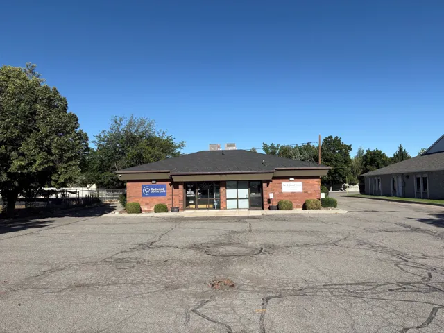 Brick exterior commercial building with a black asphalt shingle roof
