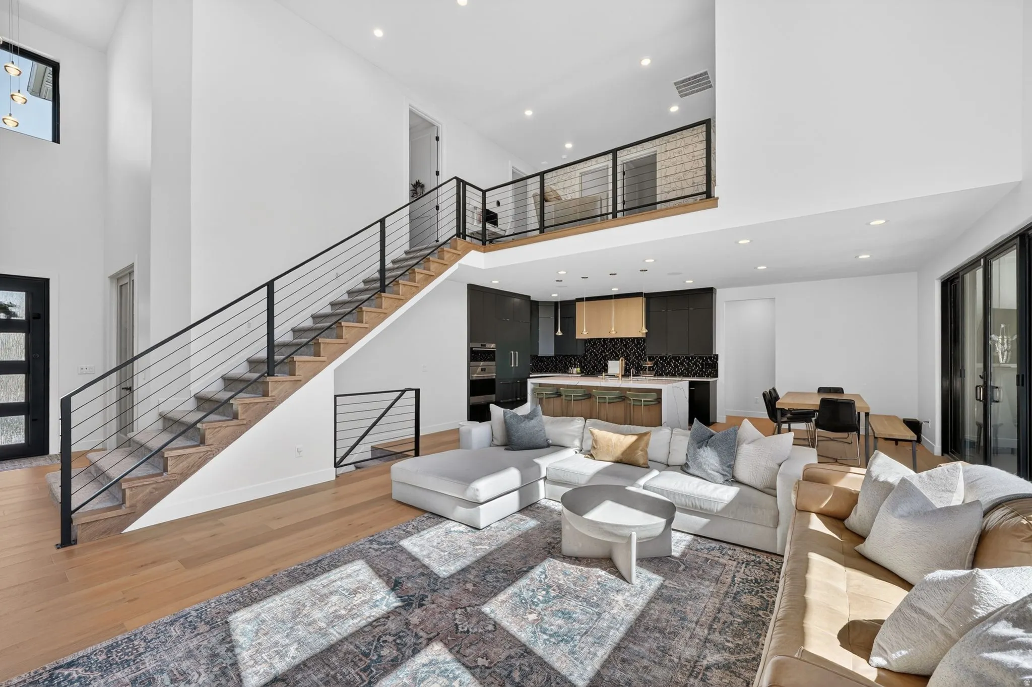 Open-concept interior featuring wood-finish flooring and a two-story ceiling