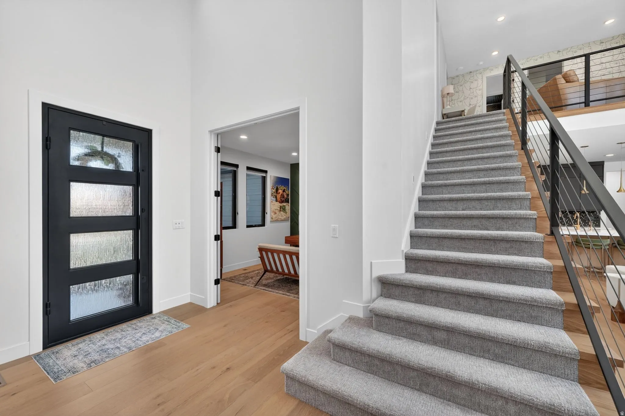 Entryway featuring a black multi-paneled door with textured glass inserts