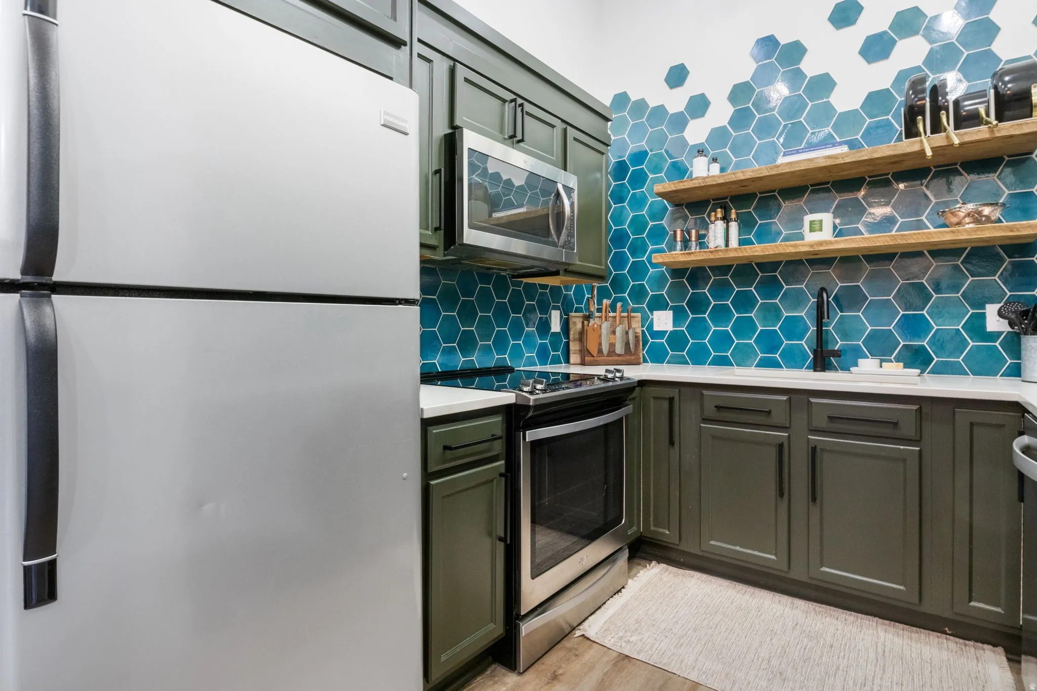 Contemporary kitchen featuring a full suite of stainless steel appliances