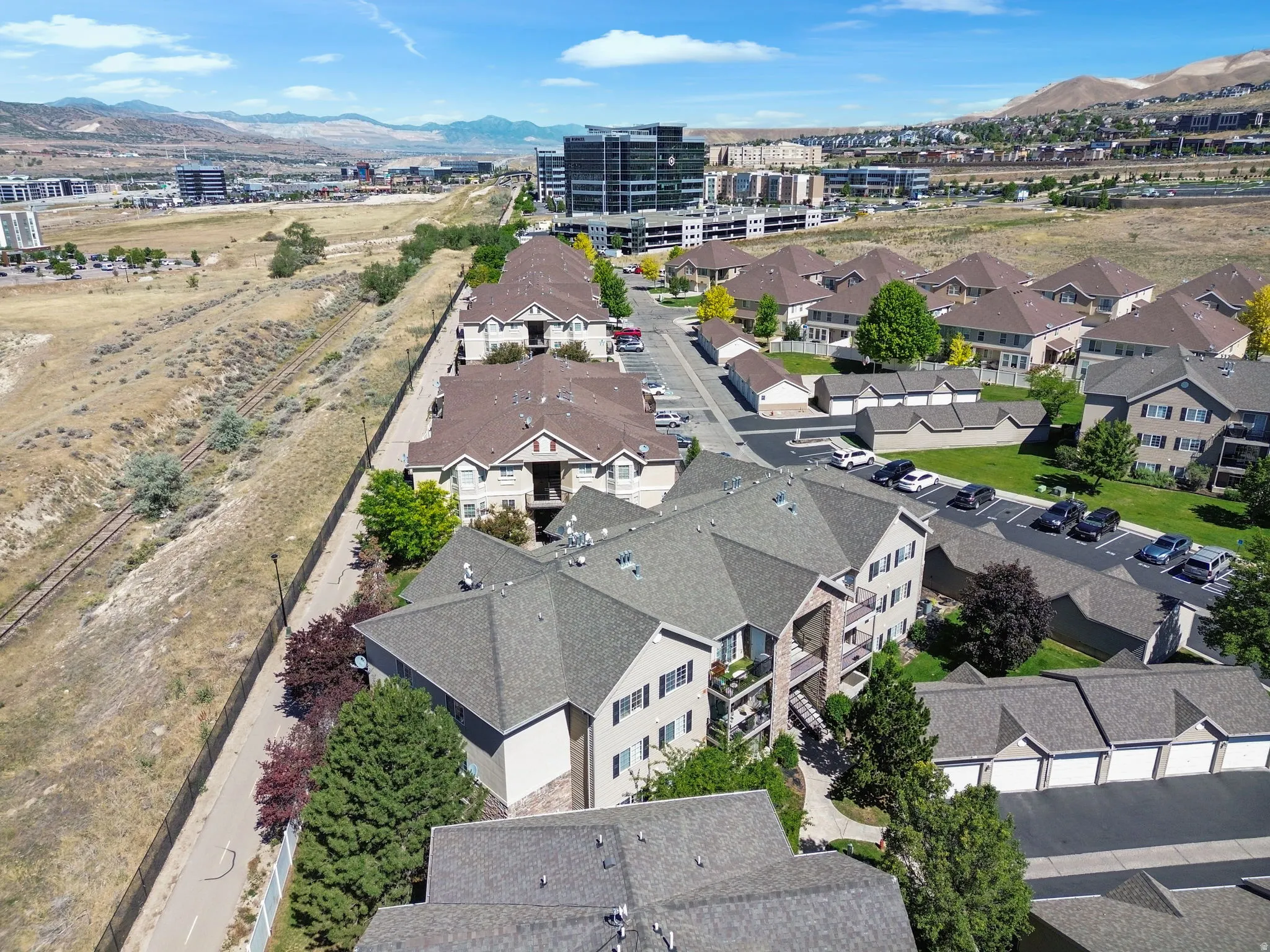 Residential complex with multiple buildings featuring pitched roofs and stucco exteriors