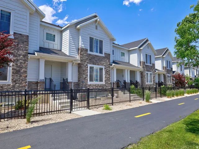 Contemporary townhome-style residences featuring stone and siding exteriors