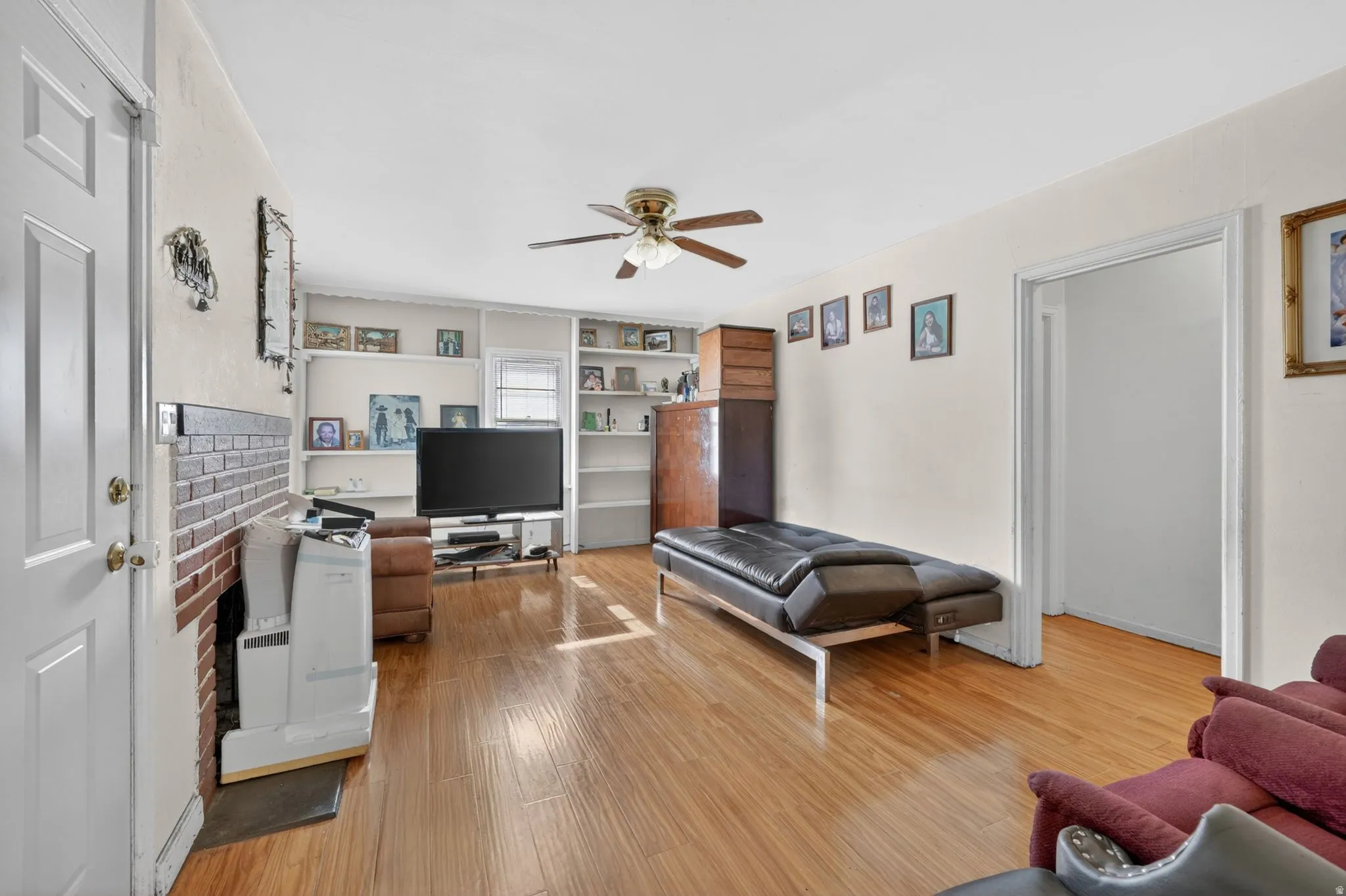 Open concept room with wood-finish flooring and a ceiling fan