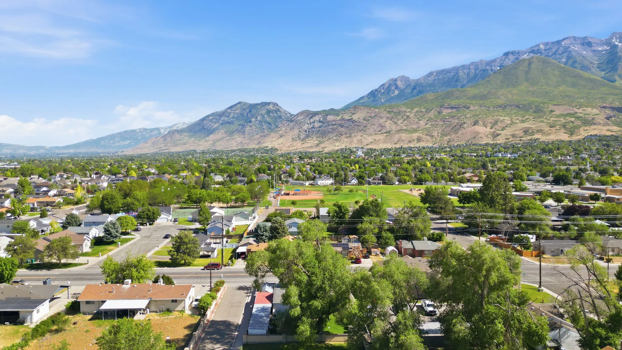 Expansive overhead perspective showcasing a residential neighborhood with distant mountains