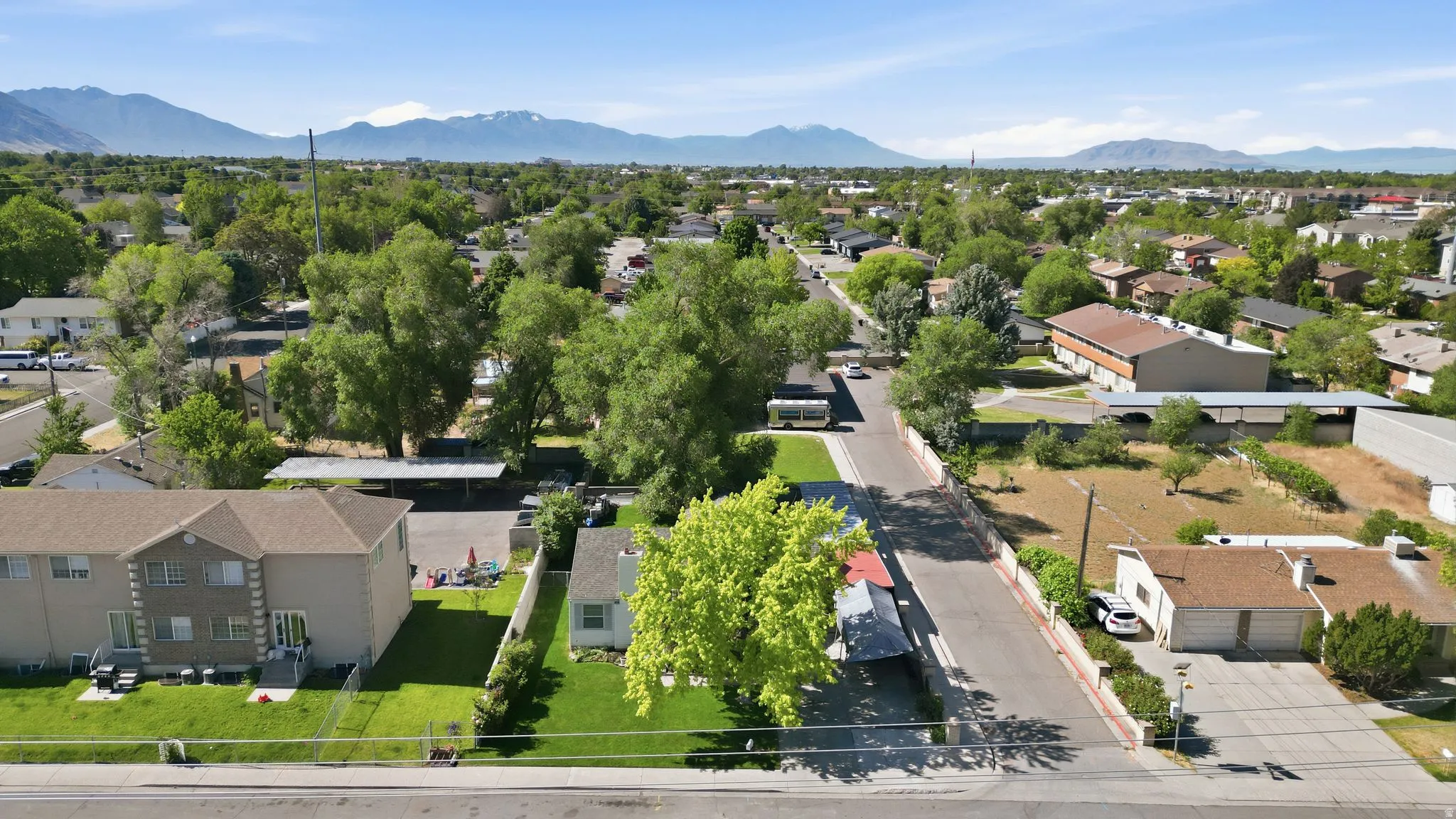 Aerial perspective showcasing a residential street with diverse property types