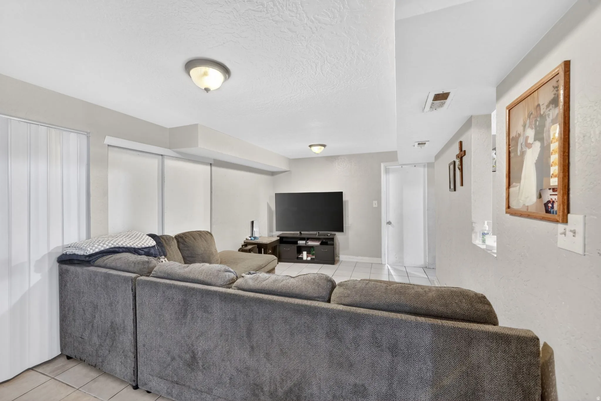 Interior living space featuring light gray wall paint and a textured white ceiling