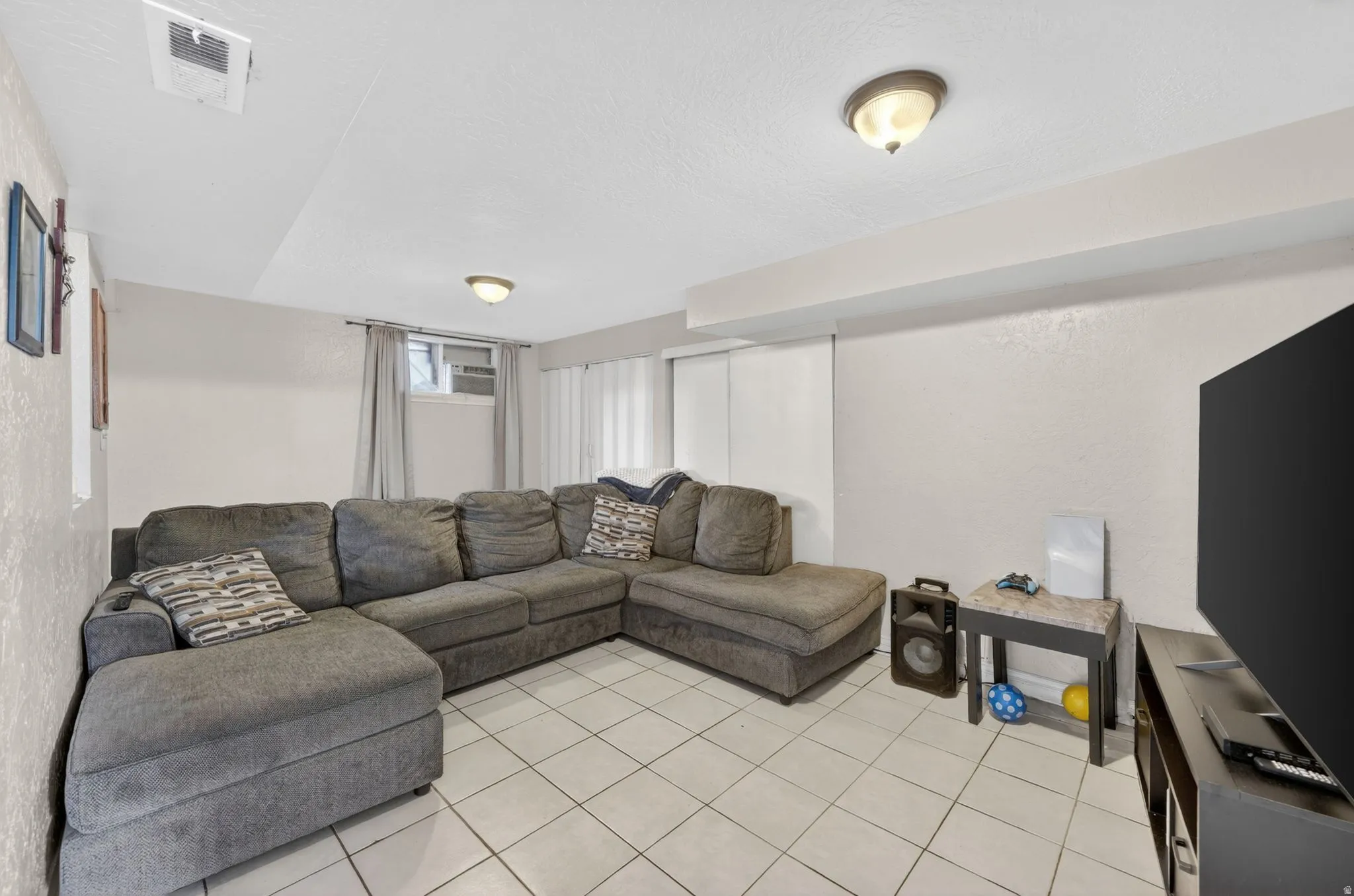 Interior space featuring light-toned walls and white tile flooring