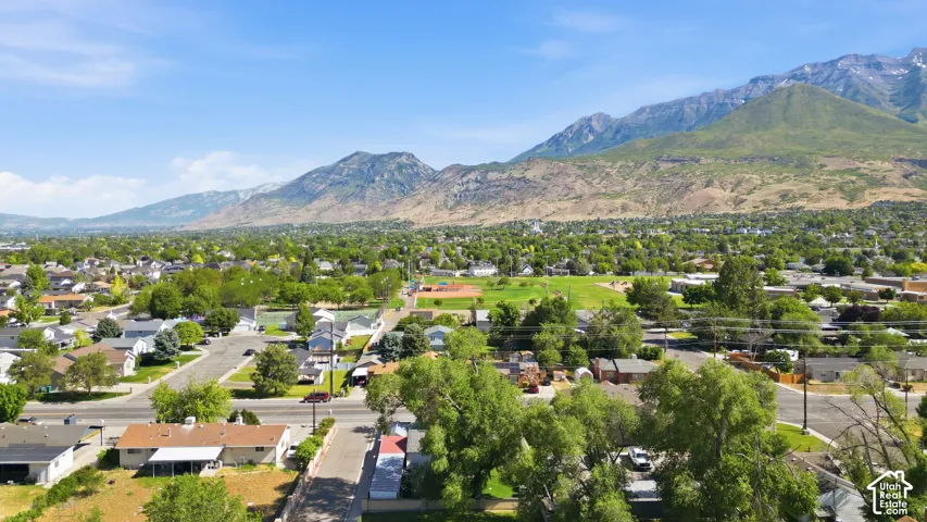 Expansive overhead perspective showcasing a residential neighborhood with distant mountains