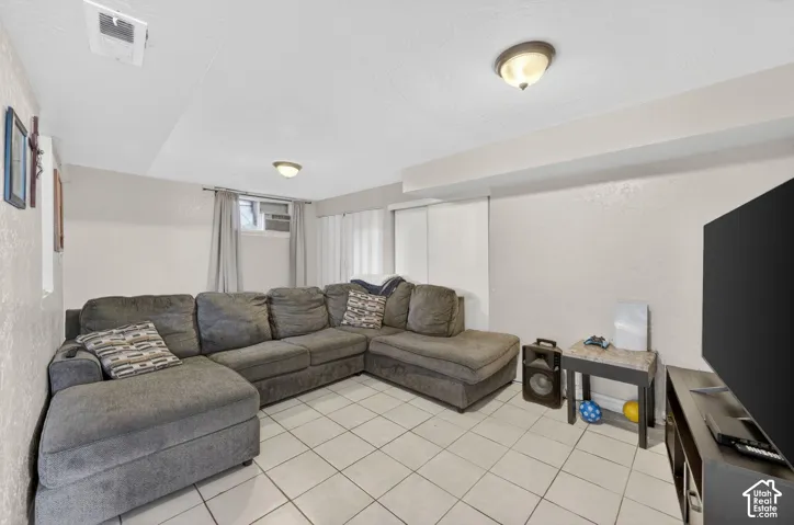 Interior space featuring light-toned walls and white tile flooring