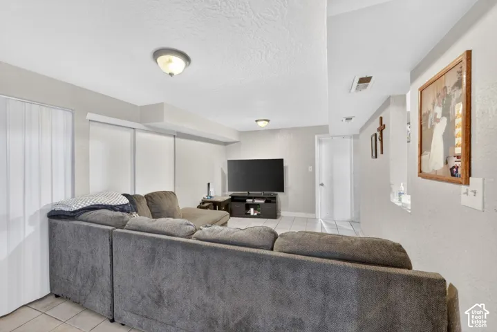 Interior living space featuring light gray wall paint and a textured white ceiling