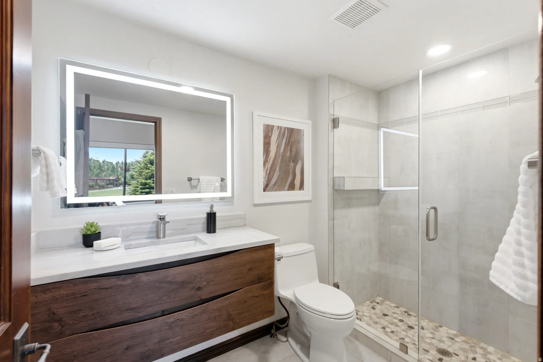 Contemporary vanity with a wood-finish base, integrated rectangular sink, and stone-finish countertop