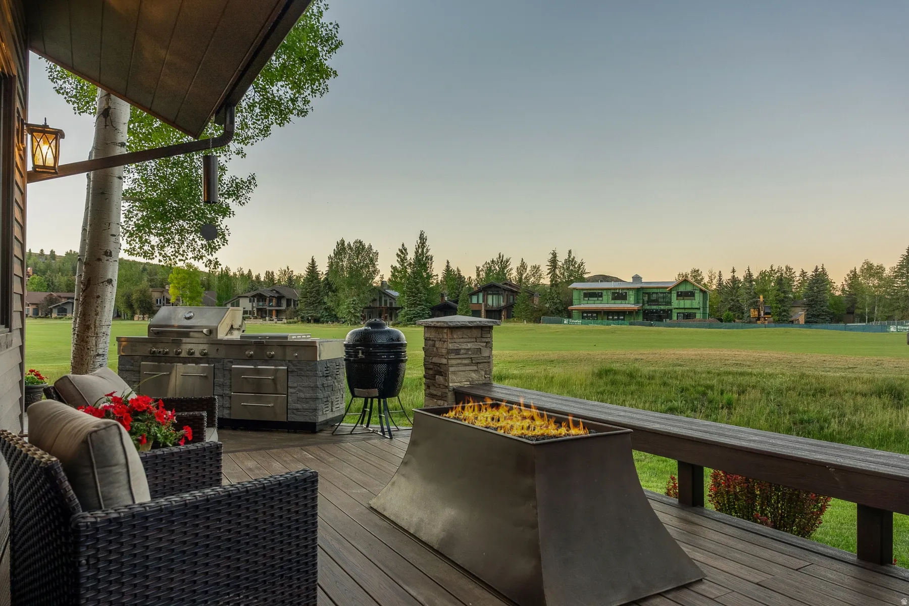 Expansive outdoor deck featuring an integrated fire pit