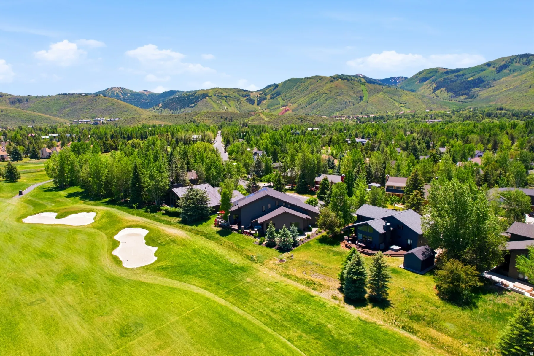 Expansive golf course frontage featuring manicured greens and sand traps