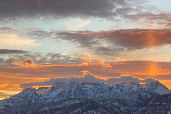 Snow-capped mountains under a vibrant sunset sky