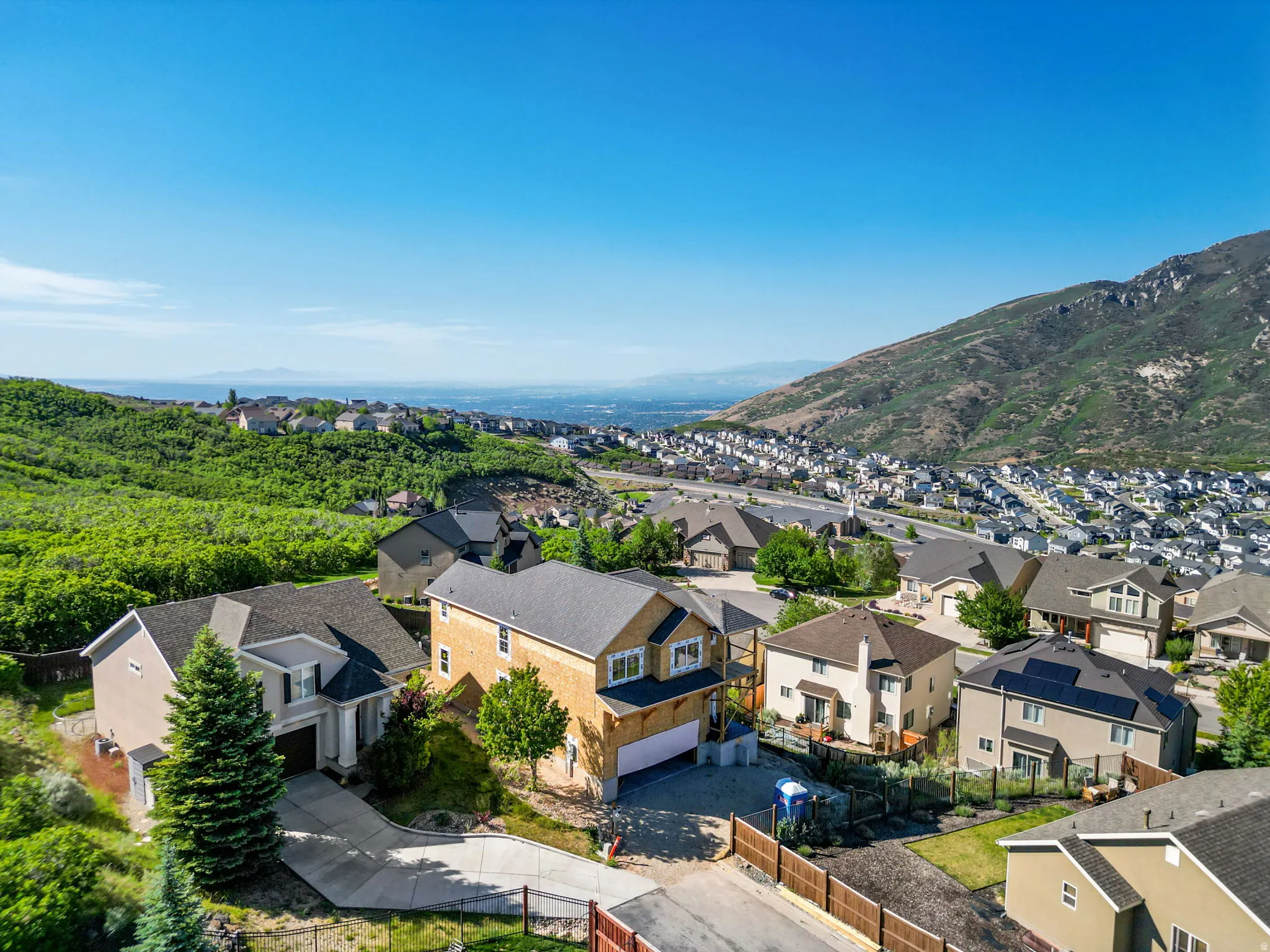 Aerial perspective showcasing a residential community nestled against a mountainous backdrop