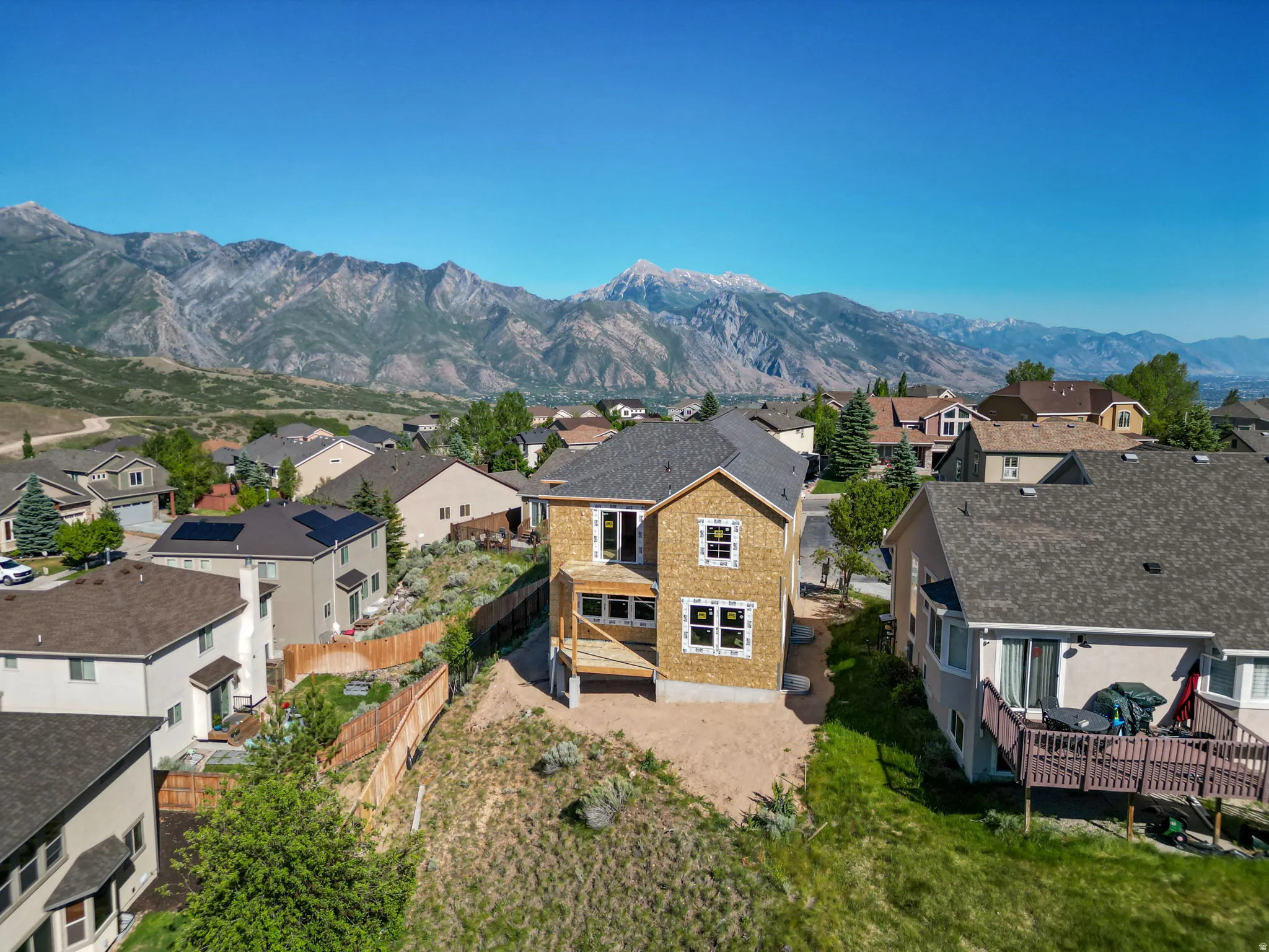 New construction property with a two-story rear deck and a partial walk-out basement