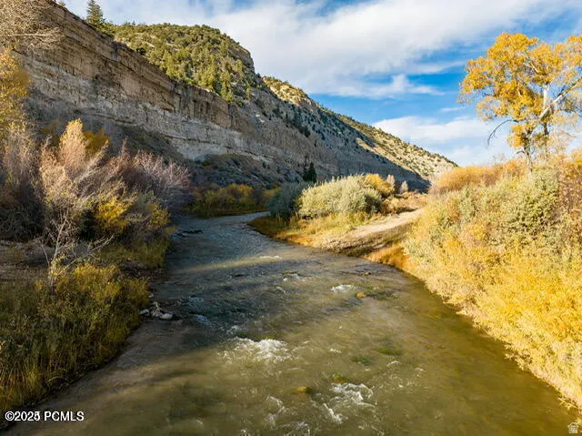Winding river with surrounding golden autumn foliage and towering rock formations