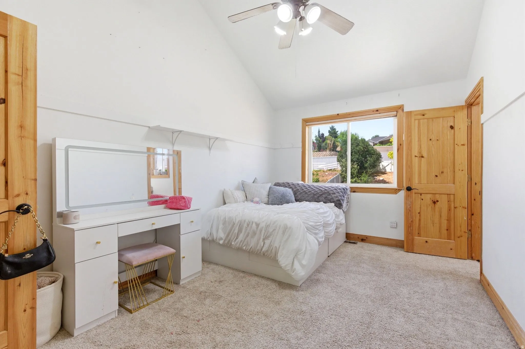 Vaulted ceilings and light-toned carpeting define this bright interior space
