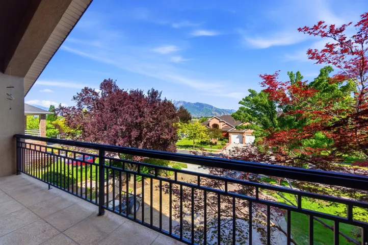 Balcony featuring a black wrought iron railing and light-toned tile flooring