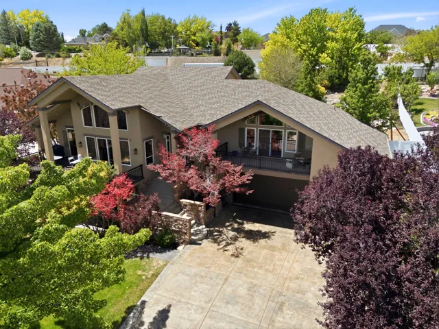 Stucco exterior residence with an attached garage and a large stamped concrete driveway