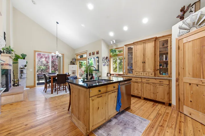 Vaulted ceilings complement the natural wood-finish flooring