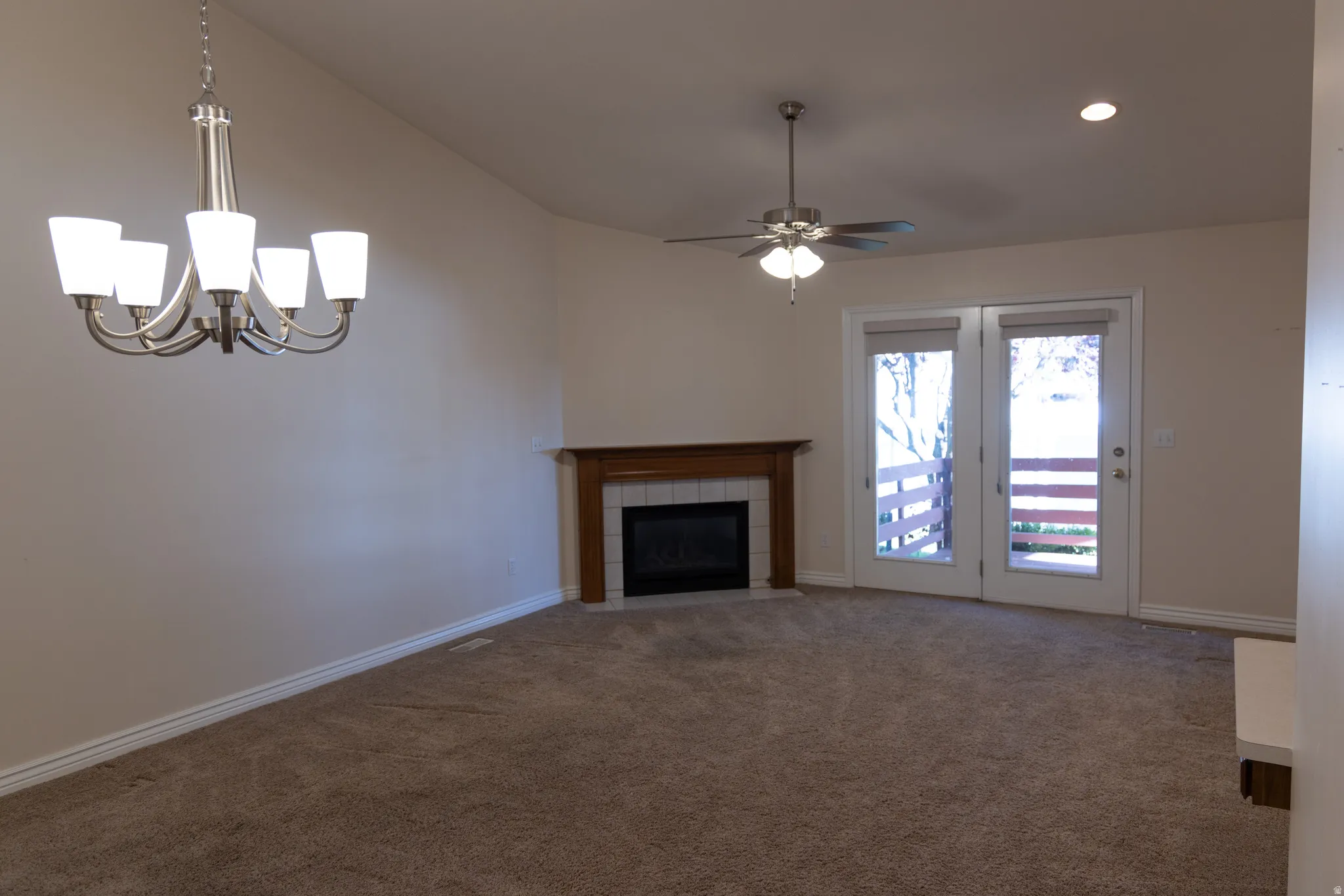 Spacious room featuring vaulted ceilings, a central ceiling fan, and recessed lighting