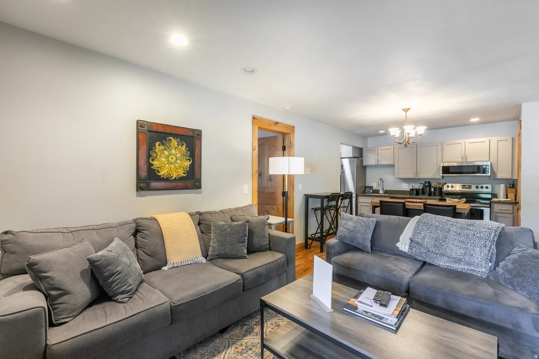 Open-concept living space with recessed lighting and wood-finish flooring