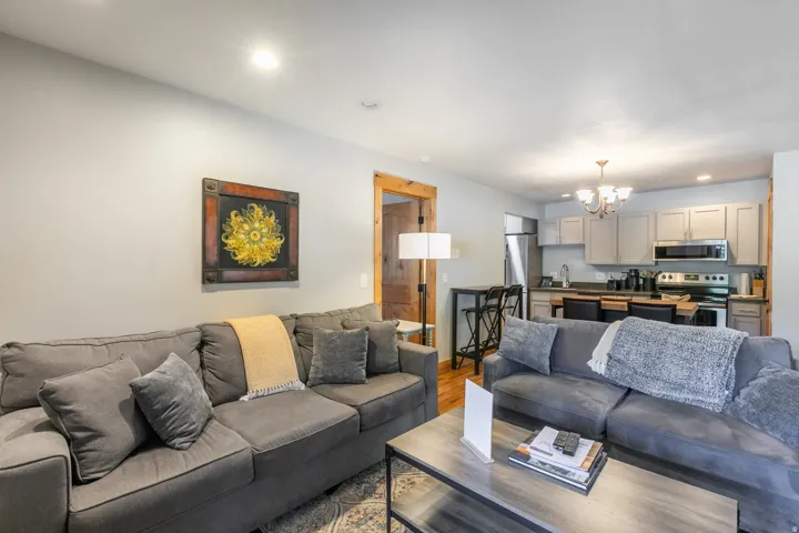 Open-concept living space with recessed lighting and wood-finish flooring