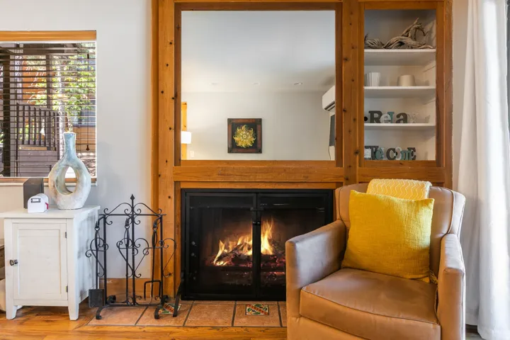 Fireplace featuring a wood surround and hearth with earth-toned tile accents