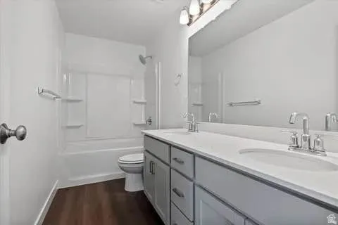 Contemporary bathroom featuring a double vanity with light gray cabinetry, white countertops, and dual chrome faucets