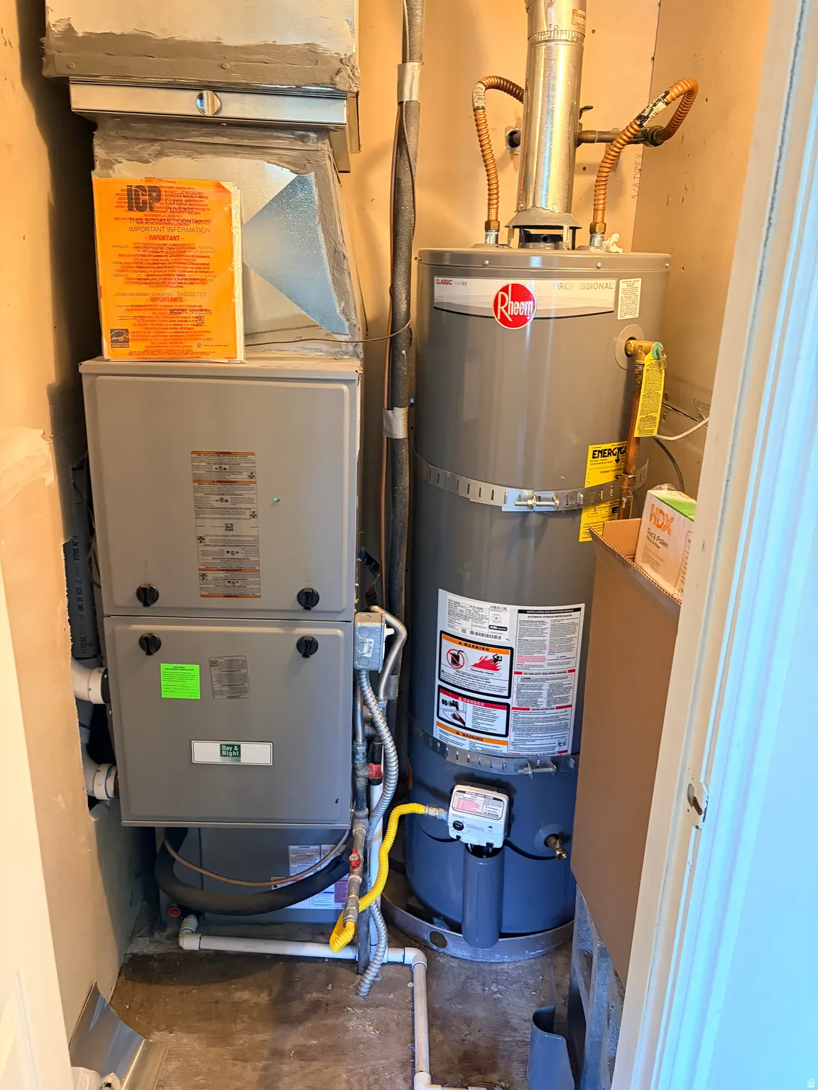 Utility closet with a Rheem water heater and ICP furnace unit