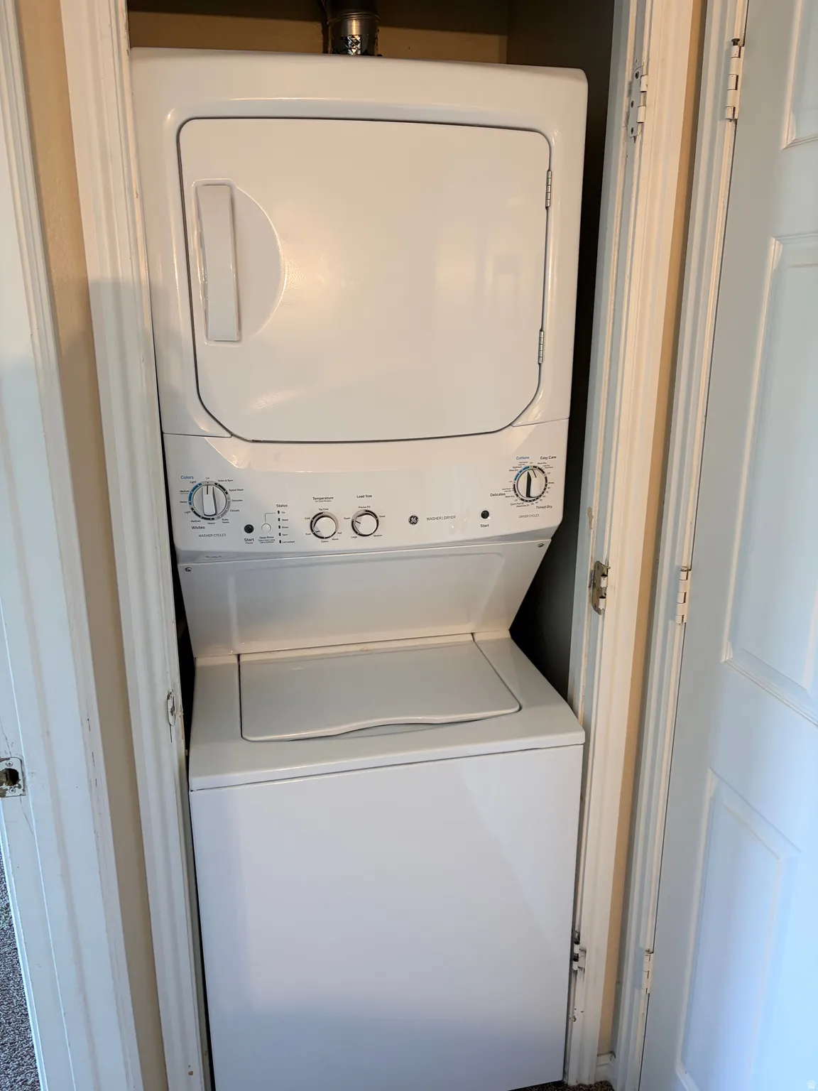 White stacked washer and dryer unit