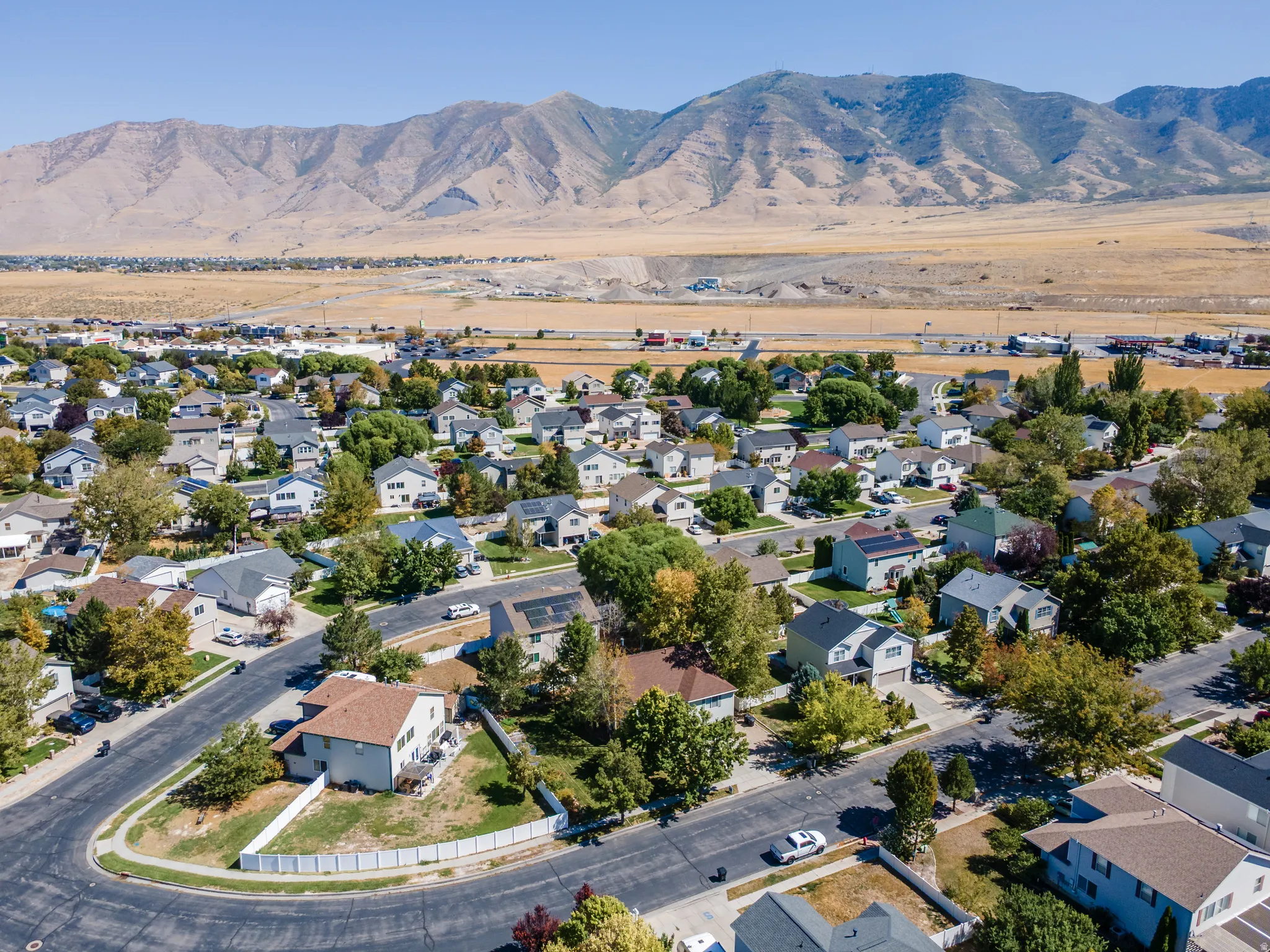 Residential neighborhood with tree-lined streets and mountain backdrop