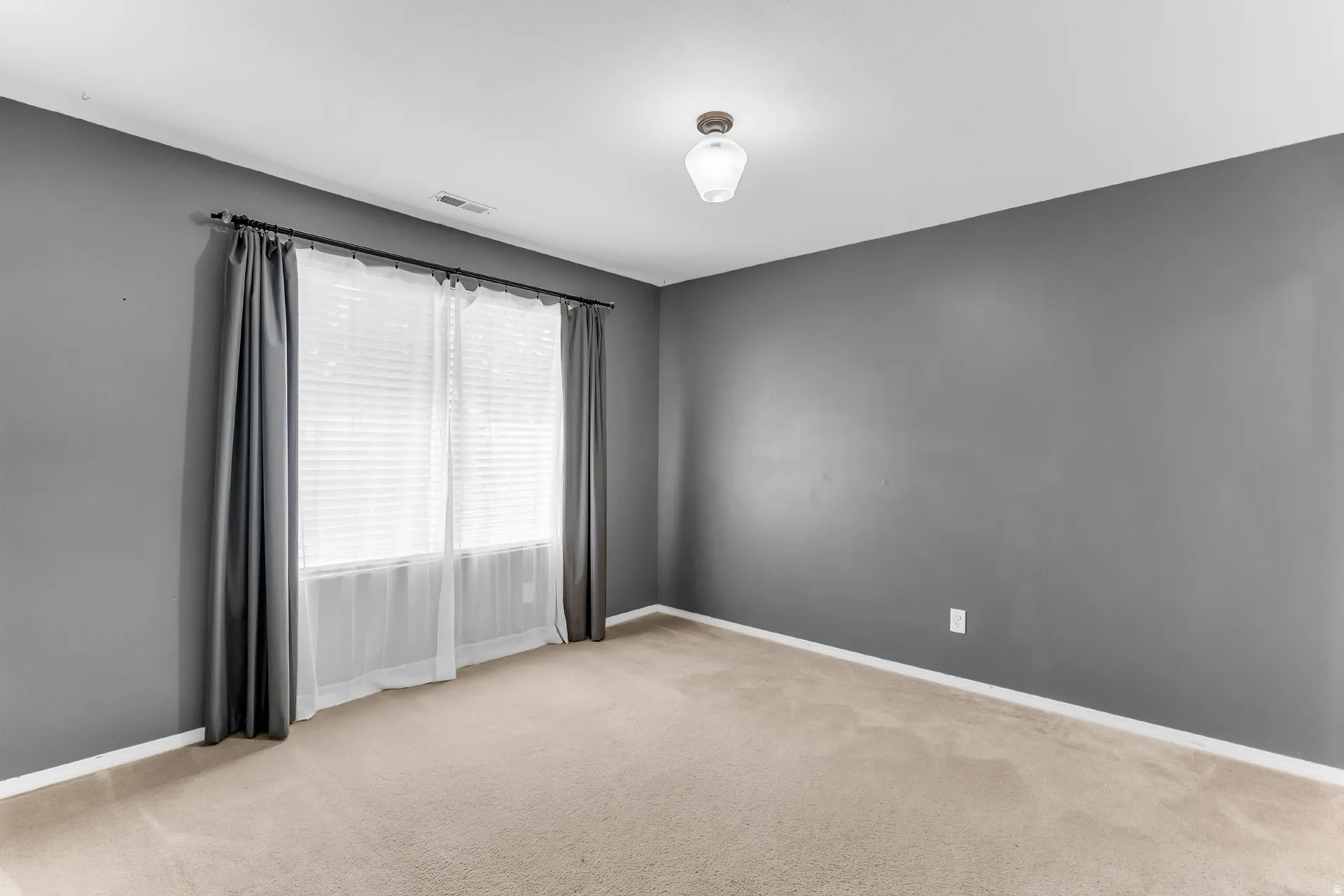 Neutral-toned carpeting, window with blinds and sheer curtains, recessed lighting, and a ceiling-mounted light fixture