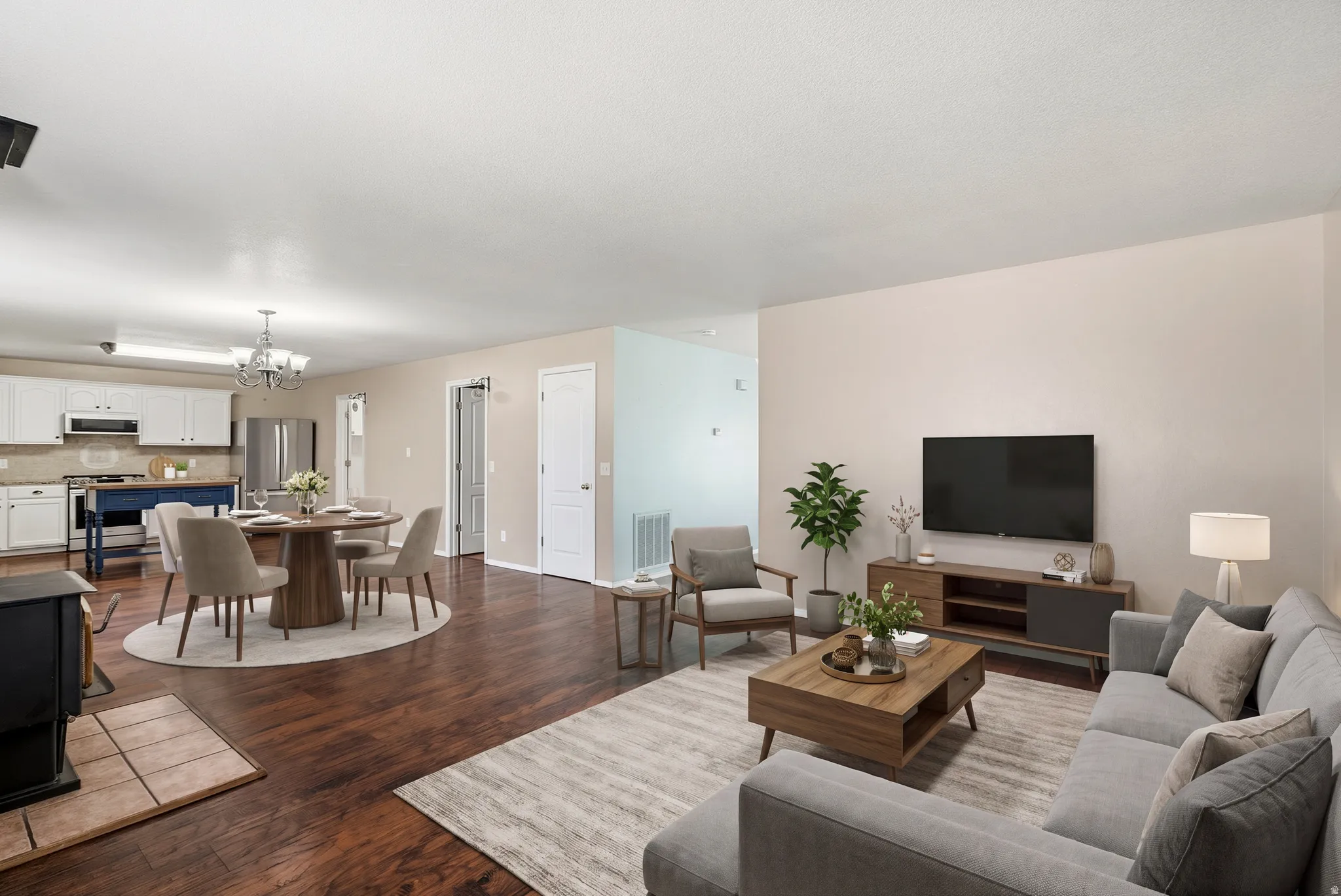 Wood-finish flooring throughout, with a tiled hearth in the living area