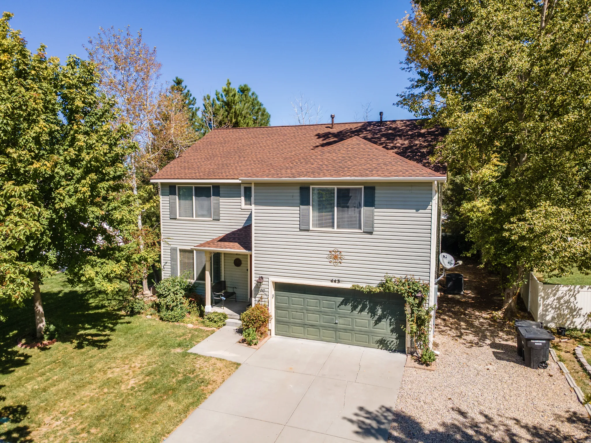 Two-story siding exterior with an attached garage, a front porch, and a concrete driveway