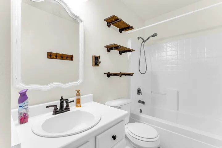 White vanity with an integrated sink and bronze-finish faucet