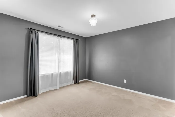 Neutral-toned carpeting, window with blinds and sheer curtains, recessed lighting, and a ceiling-mounted light fixture