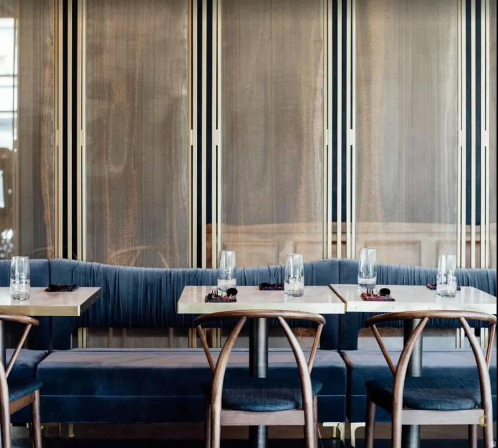 Custom banquette seating with deep blue velvet upholstery