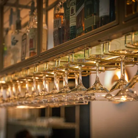 Built-in bar cabinetry featuring a glass-front display and integrated stemware rack
