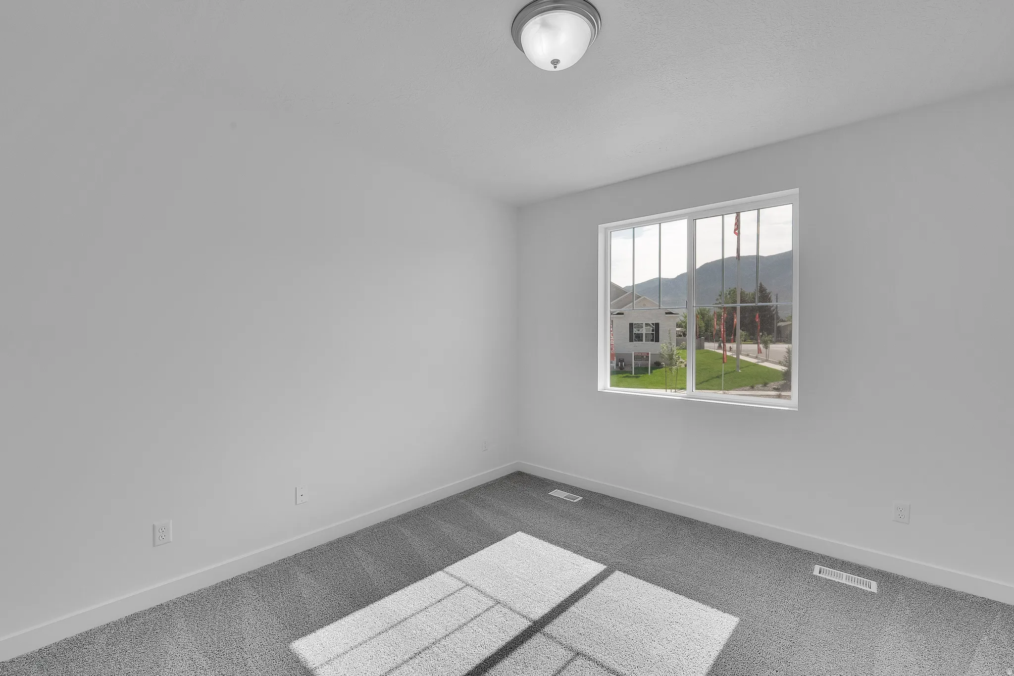 Neutral-toned interior room with wall-to-wall carpeting and white trim