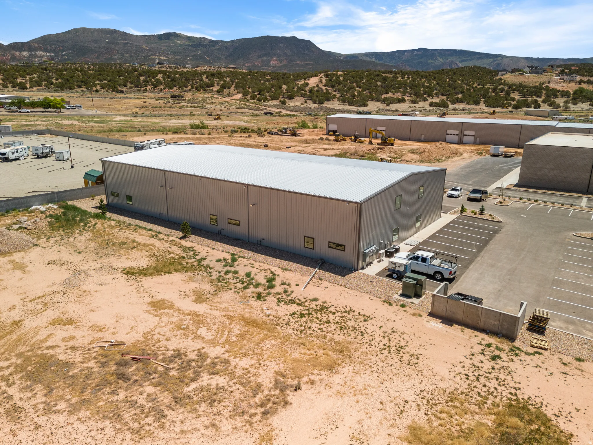 Industrial building with metal siding and a light-colored metal roof
