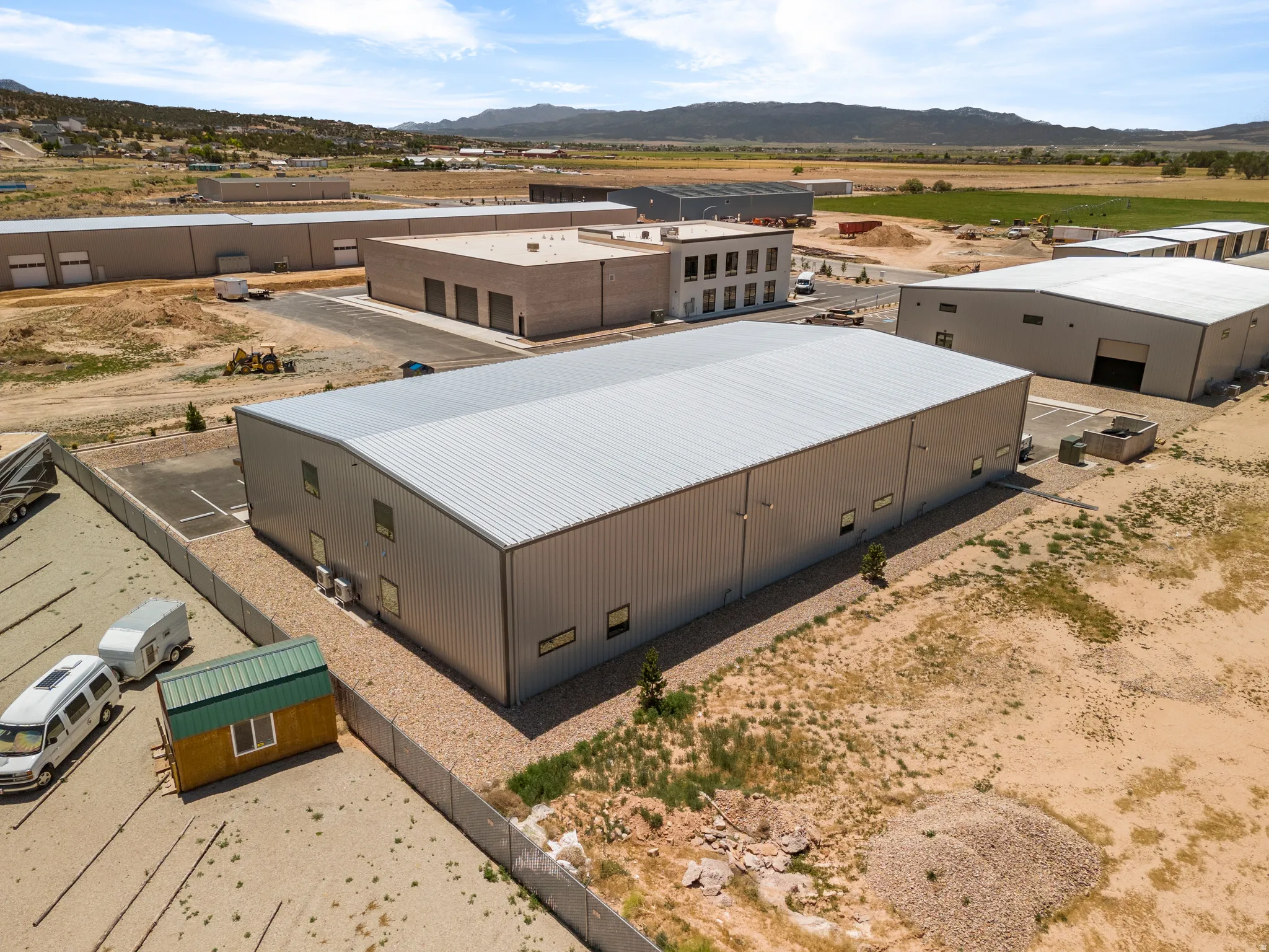 Large industrial building featuring a metal roof and corrugated metal siding